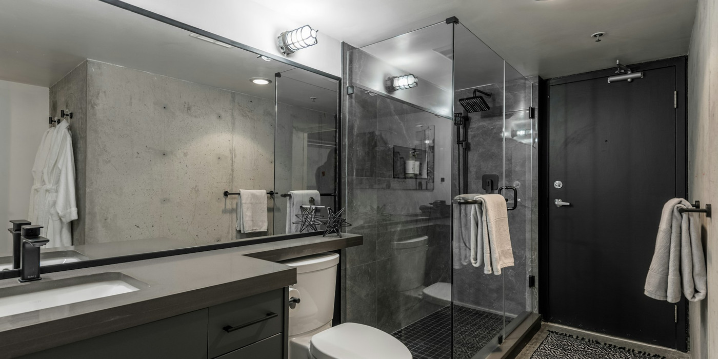 A glass shower screen in a tiled bathroom