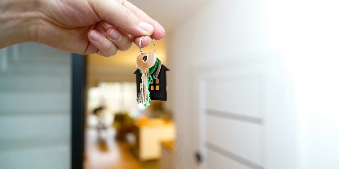 A set of house keys being handed over
