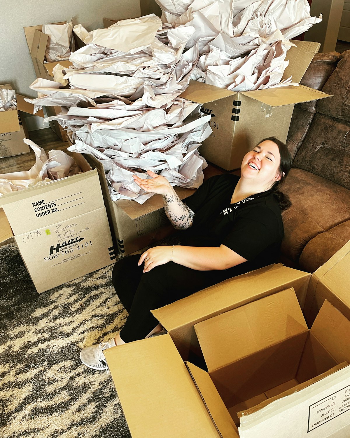 Renter sitting among packed moving boxes before the final clean
